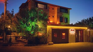 A two-story building with a brick facade, a visible entrance, and a sign indicating a restaurant or cafe. - Kapadokya Konak (Nevsehir)