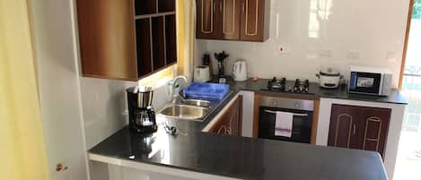 Microwave, coffee/tea maker, cookware/dishes/utensils
