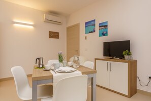 Deluxe Apartment, Kitchenette, Pool View | Living area | 40-inch flat-screen TV with digital channels, TV - Travini Hotel Residence (Marsala)