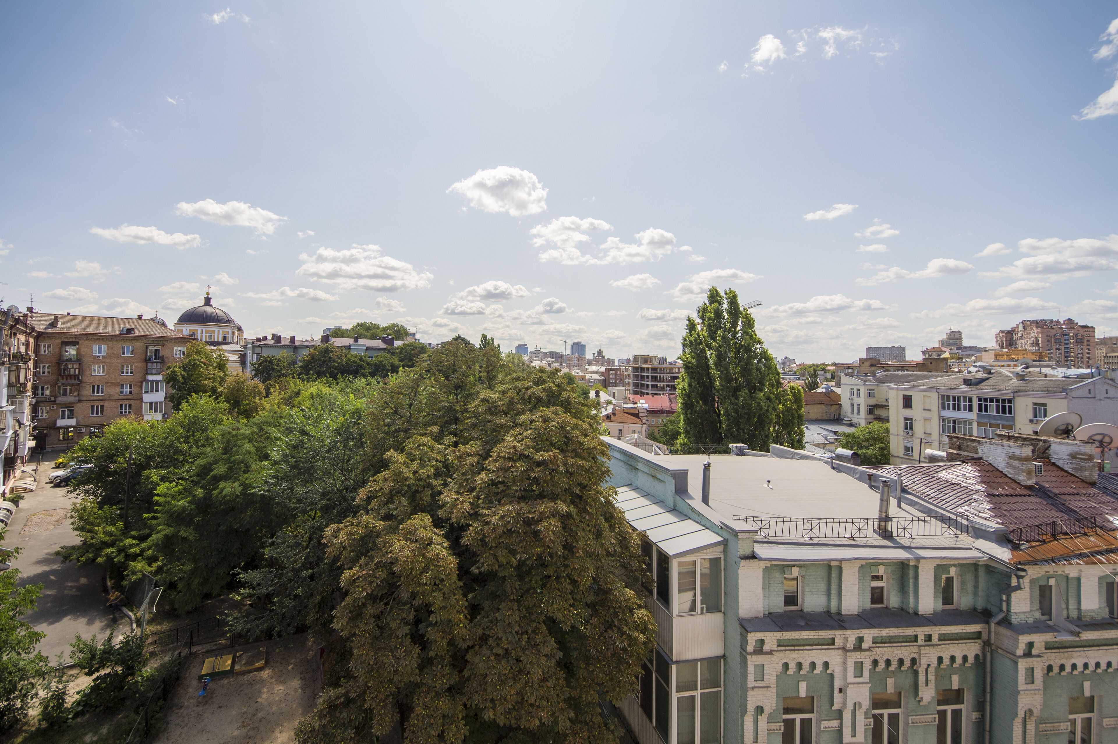 A cityscape with a mix of historical and modern buildings, including a prominent dome structure.