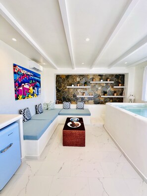 Design House, Patio, Pool View | Living area | 28-inch flat-screen TV with satellite channels, TV - Arlene Suites (Santorini)