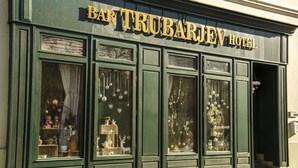 La façade du Bar Trubarjev Hotel, avec ses grandes fenêtres ornées de décorations de Noël.