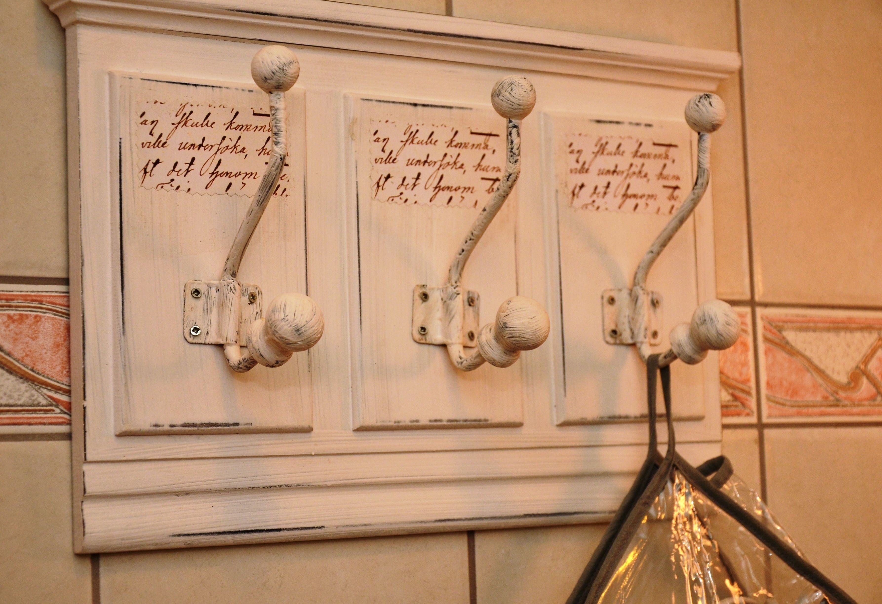 A wall-mounted light switch with three separate controls.