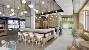 A modern bar area with a central counter, white bar stools, and hanging spherical lights. - Q-Box Hotel Shanghai Nanqiao (Shanghai)