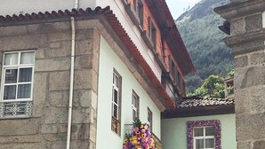 Ein mehrstöckiges Gebäude mit Steinmauern und einem roten Ziegeldach.