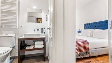 Une salle de bain avec des toilettes, un lavabo et un miroir.