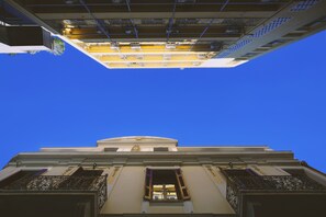 A building with a classical architectural style, featuring a prominent central dome and symmetrical balconies. - Central Apartments in Psiri (Athens)