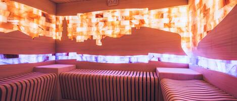 A sauna with wooden benches and a ceiling with light patterns.