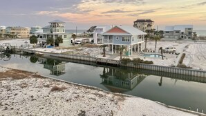 A coastal property with a dock, a swimming pool, and a beach view. - Family Friendly Escape -Waterfront, Firepit, 3 Masters, Fishing, Kayaks & More (Navarre)
