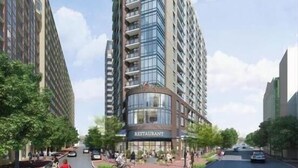 Un immeuble moderne de grande hauteur avec un restaurant situé au rez-de-chaussée.