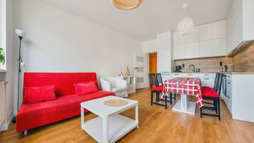 Laptop workspace, iron/ironing board, bed sheets