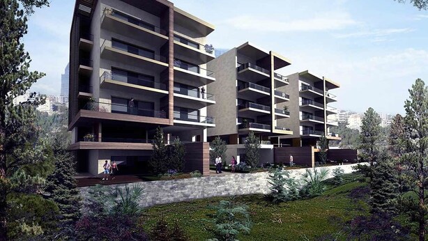 A modern multi-story residential building with balconies, surrounded by greenery and trees. - Family-Friendly Home in Greater Beirut (Baabda)