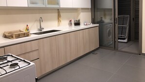 A modern kitchen with a built-in stove, a sink, and a dishwasher. - Family-Friendly Home in Greater Beirut (Baabda)