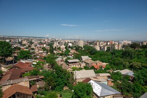 A cityscape with a mix of residential and commercial buildings, dense urban layout, and clear skies.