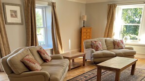 A living room with two sofas, a coffee table, and a rug. - Cottage for 6 in stunning rural location (Beech) (Crawfordjohn)
