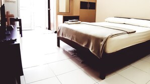 A hotel room with a bed, a desk, and a wardrobe. - Prapai Place Don Muang (Bangkok)