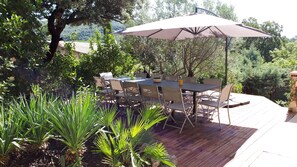 Relax on the elevated deck surrounded by lush greenery and enjoy the view.