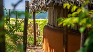 A rustic thatched-roof structure with a view of the ocean. - Varatraza Wind Riders (Antsiranana)
