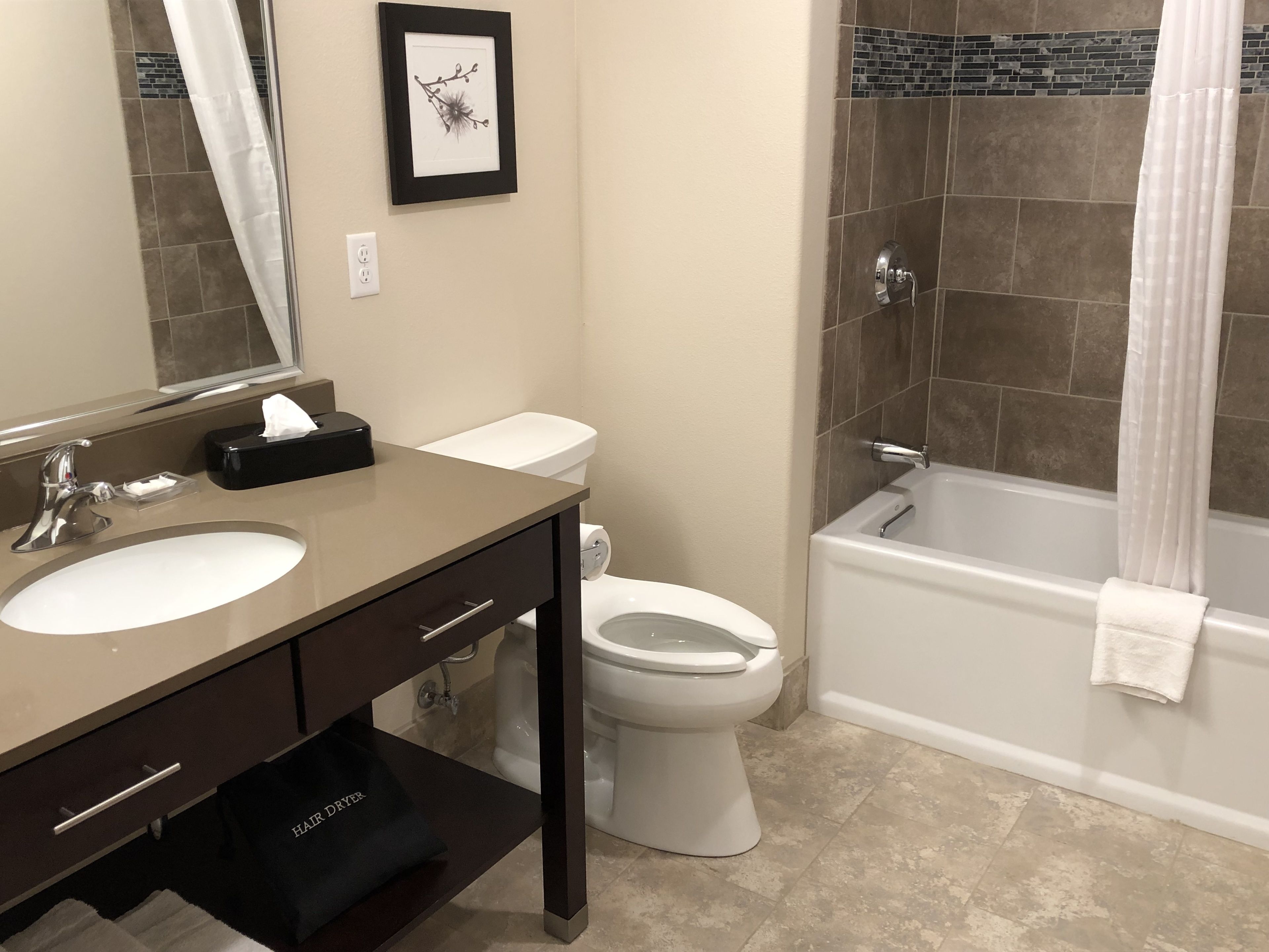 A bathroom with a sink, toilet, and bathtub.