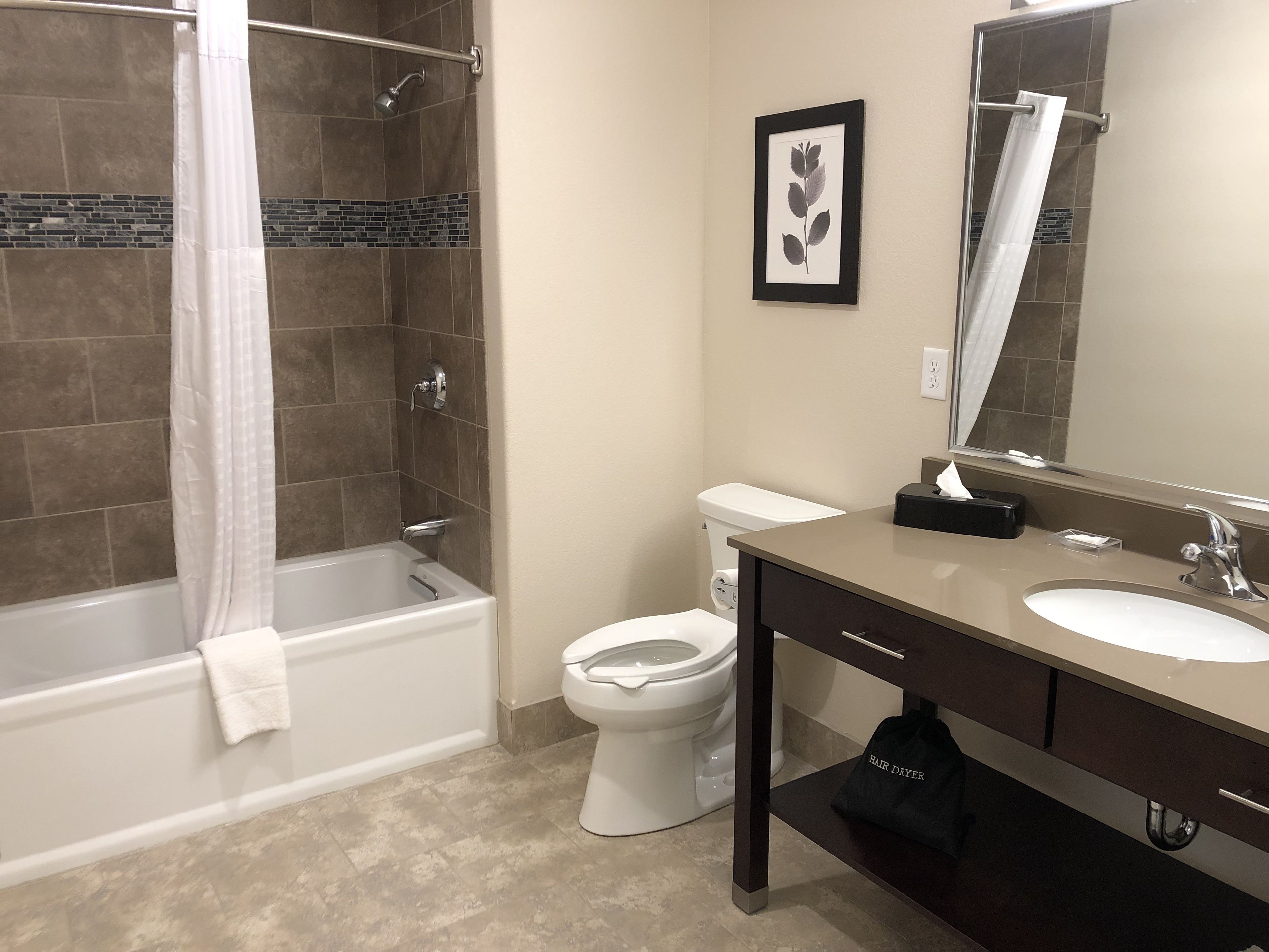 king one-bedroom suite | bathroom | deep-soaking bathtub, free toiletries, hair dryer, towels