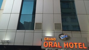 The exterior of the Grand Oral Hotel with a modern design, featuring a prominent sign at the top and a logo below. - Grand Oral Hotel (Istanbul)