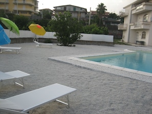 Seasonal outdoor pool, open 10:00 AM to 6:30 PM, pool umbrellas