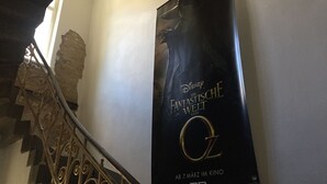 A staircase with ornate metal railings and a poster advertising 'The Fantastical World of Oz' in 3D. - Loft 1. 4 in the heart of Berlin (Bezirk Friedrichshain-Kreuzberg)