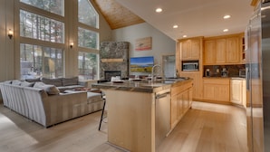 A spacious kitchen with wooden cabinets, a large island, and a built-in oven.