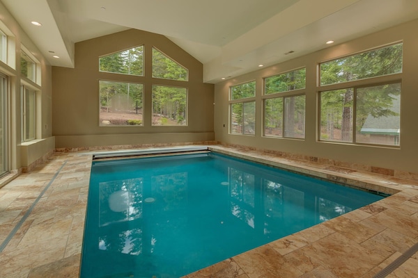 - Indoor swimming pool with forest views through large windows
- Relax in year-round comfort with natural light streaming in
- Perfect family-friendly feature for your mountain getaway