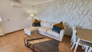 A living room with a sectional sofa, a coffee table, a dining table, and chairs. - El Rincon 3 (Los Cristianos)