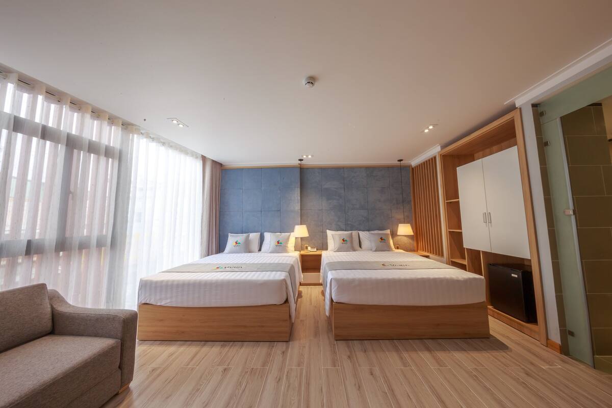 Deluxe Quadruple Room, 2 Queen Beds | Minibar, in-room safe, desk, blackout curtains