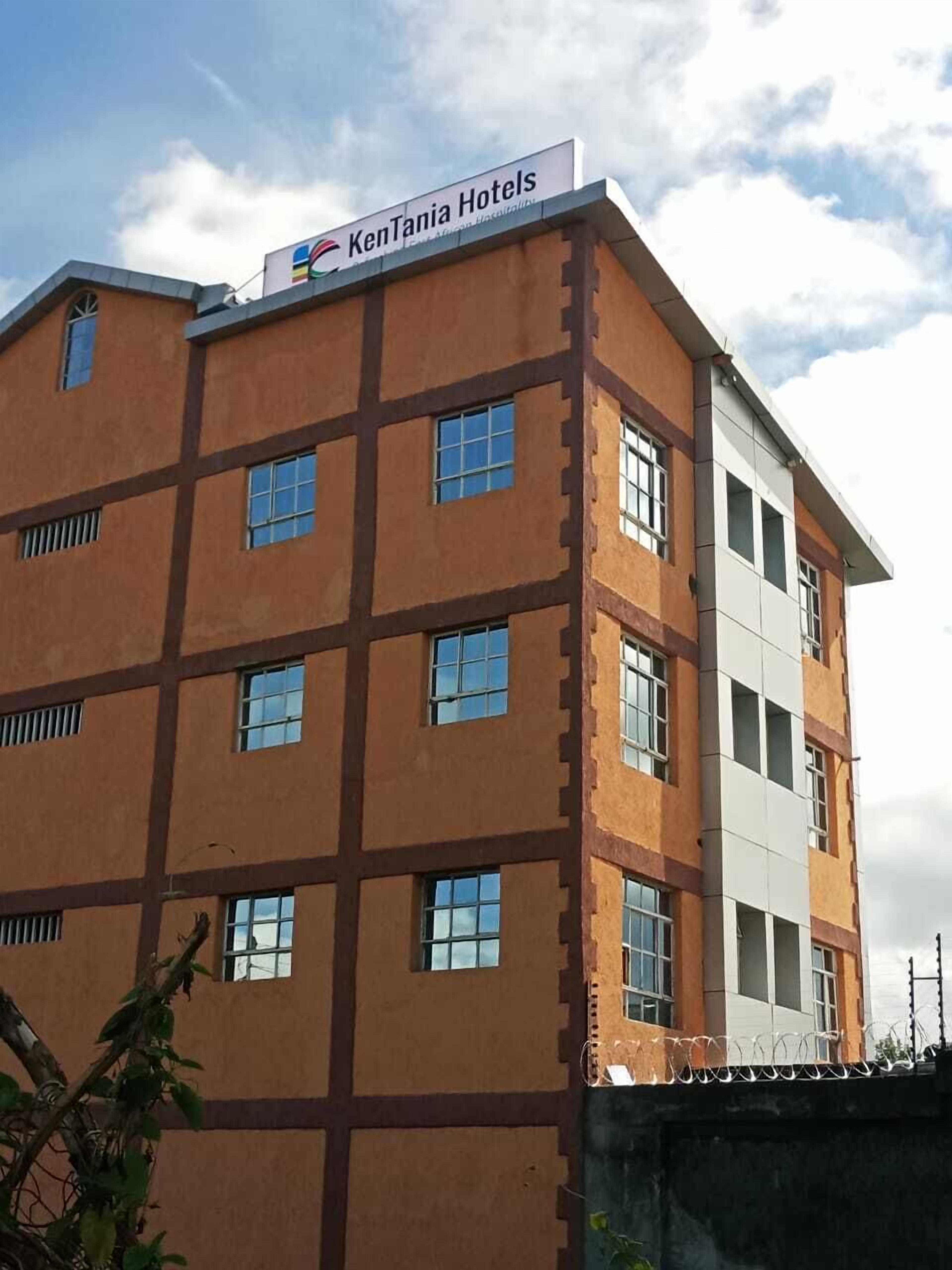 A multi-story hotel building with a sign reading 'KenTania Hotels.'