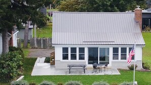 A house with a patio, a flag, and a dock. - Quiet Lakefront property on Cassadaga Lake WiFi & 2 car parking. (Cassadaga)