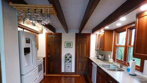 A kitchen with wooden cabinets, a refrigerator, a dishwasher, and a sink. - Beautiful, 200 year old Log home - Secluded, 30 Min. from Downtown (Indianapolis, Acton)