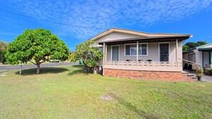 A single-story house with a front porch, a brick foundation, and a tree in the yard. - Marlene Court -  Air con, boat parking (South West Rocks)