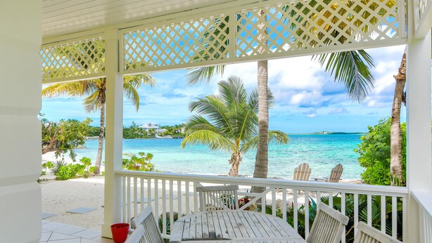 A covered outdoor seating area with a view of the beach and ocean. - 11 steps to the Ocean  (George Town)