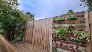 A wooden fence with a vertical garden.
