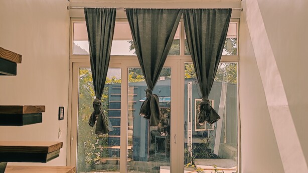 A modern interior with a staircase, a sofa, and a view through a glass door. - Indian Culture Hostel (Narendranagar)