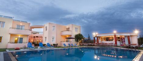 Een buitenzwembad en ligstoelen