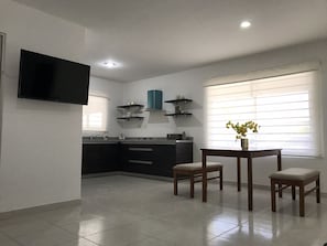 Enjoy cooking in this well-equipped kitchen with a central island, flat-screen TV, and dining area.