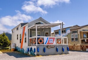 A building with a porch, life preservers, and a mural.
