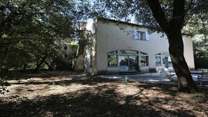 A rustic building with large windows and a covered patio area. - House with character beetween Nimes (15km) and MontpellierHouse with character (Boissières)