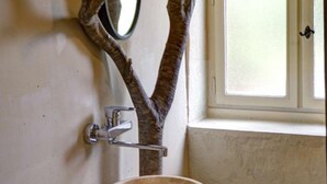 A bathroom with a wooden tree-shaped mirror, a sink, and a window with a door. - Large house with heated private pool and pets allowed (Vivans)