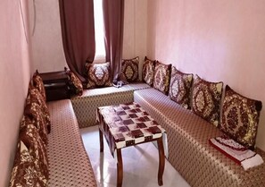 A cozy living room with a sofa set, a wooden coffee table, and patterned cushions. - Apartment Atlas La corel Marrakech 4154 (Marrakech)