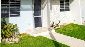 A modern two-story building with a flat roof, large windows, and a concrete pathway leading to the entrance. - Private pool, Oceanview, Centrally located! (Puerto)