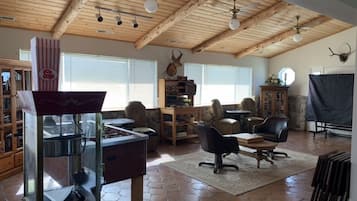 Cozy living area with a high ceiling, fireplace, and comfortable seating.
