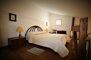 Cozy retreat with a neatly made bed, nightstand, and dresser.