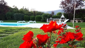 A pool area with lounge chairs and a barbecue grill. - Prestigious penthouse with large panoramic terrace (Marciaga)