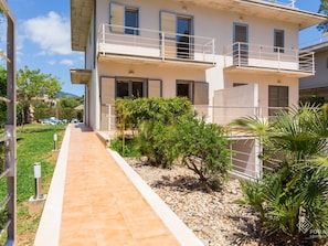 Stroll through the beautifully manicured grounds to the entrance of this serene residence.