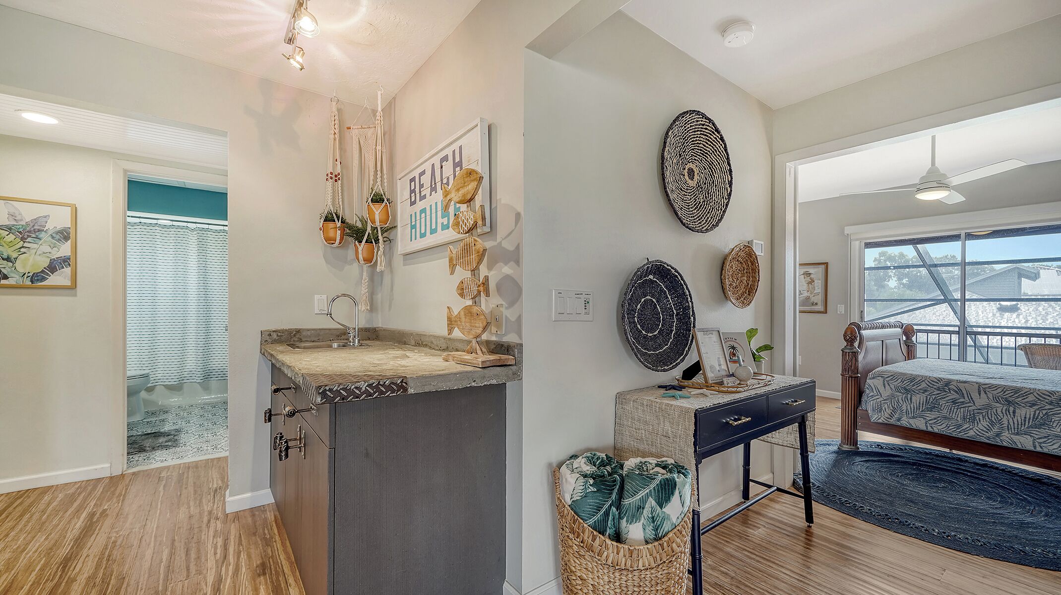 A modern bathroom with a sink, vanity, and a shower area.